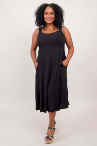 Model with hands in pockets wearing the black bamboo linen dress