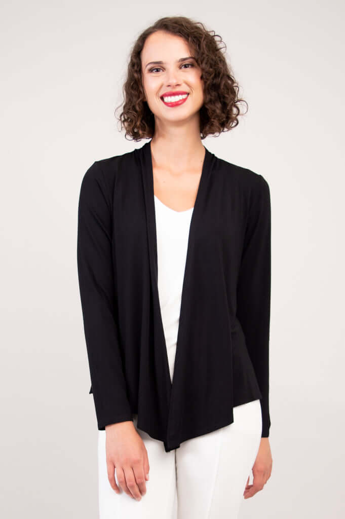 Model wearing a black open-front cardigan with long sleeves and white pants