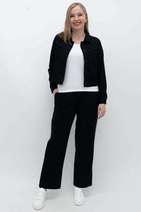 Model wearing black Melodie Pant with white top and black jacket