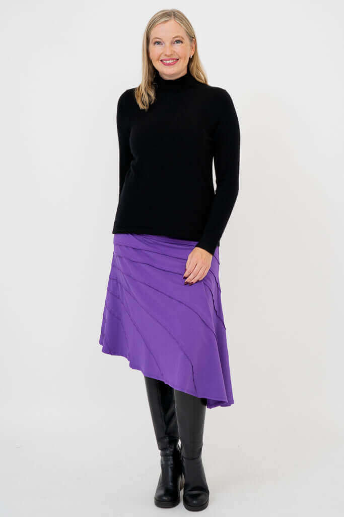 Model wearing black sweater and Beverly Skirt in violet
