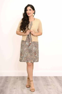 Model wearing floral dress with cardigan, smiling