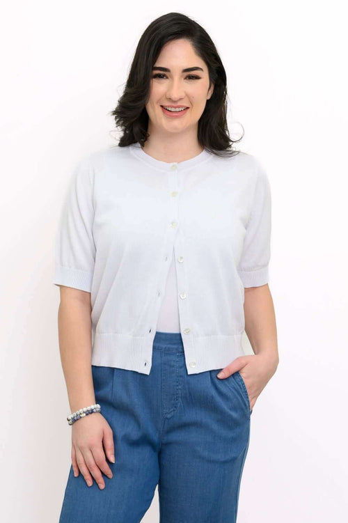 Model wearing a light short-sleeve button-up cardigan with blue pants