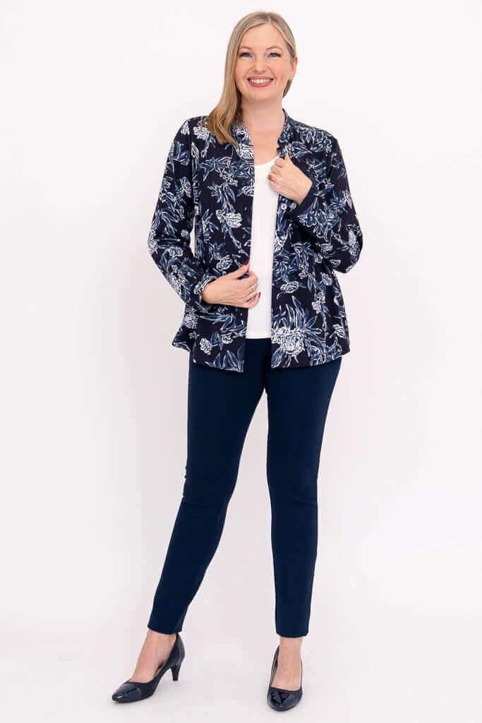 Woman modeling navy floral blouse open over white shirt, full body view