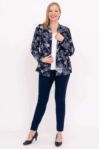 Woman modeling navy floral blouse open over white shirt, full body view