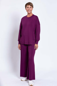Woman modeling sustainable relaxed bamboo crew neck top and wide-leg pants