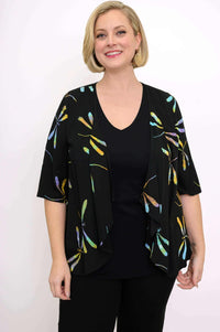 Smiling woman modeling the Toucan Jacket with open front and artistic dragonfly print