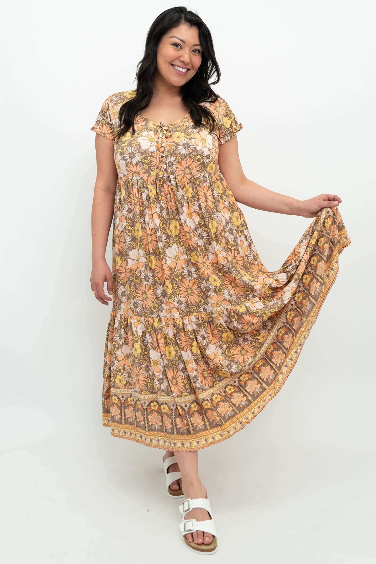 Model showing flowy tiered skirt of floral Sharpie Dress from the front