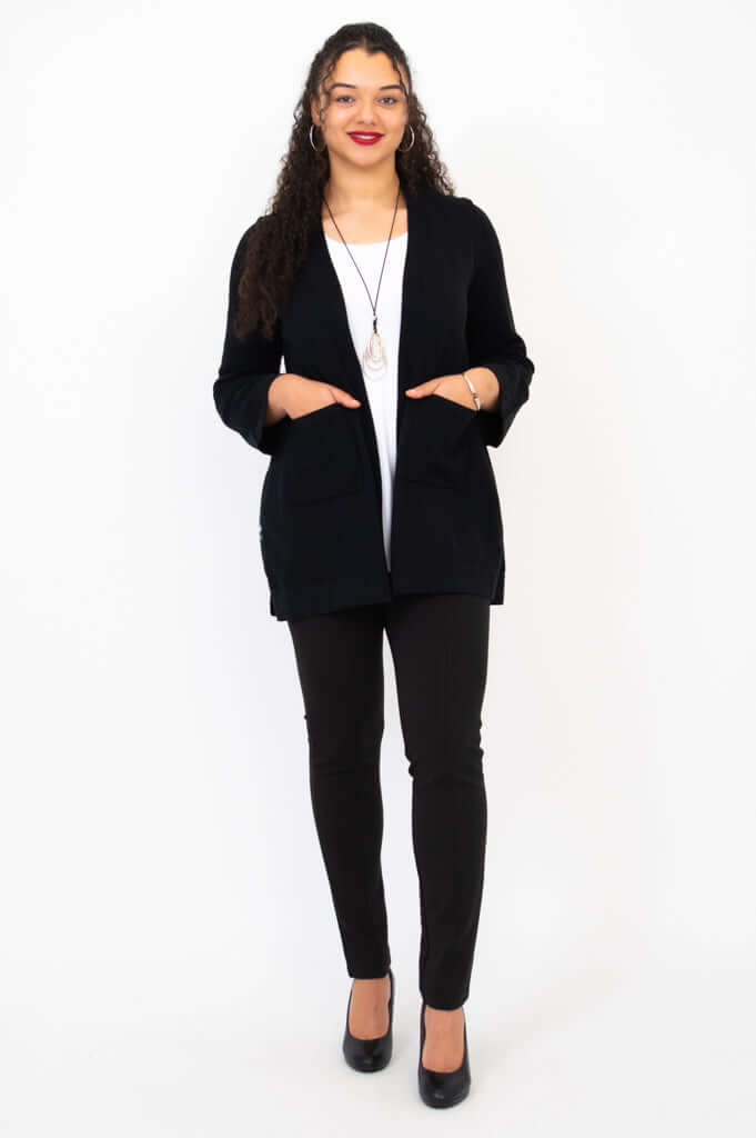 Model standing with hands in pockets, showcasing black Dallas Cardigan