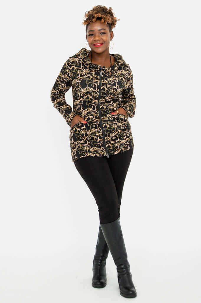 Woman posing with both hands in pockets, wearing vine print hooded jacket