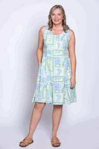 Model standing with one hand in pocket in pastel Arden dress