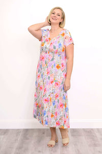 Model posing in the floral dress with hand behind neck, showing neckline and buttons