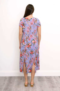Back view of woman wearing short sleeve lilac floral patterned maxi dress with sandals