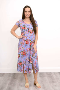 Front view of woman wearing long dress with pink and purple floral print