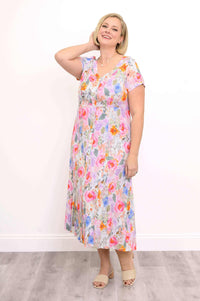 Model in Morgan floral dress smiling with hand on neck