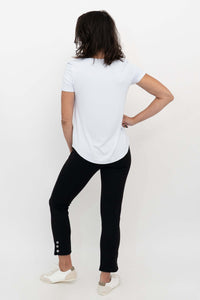 Back view of a model wearing the Nadine Crop Pant, highlighting the button detail at the hem