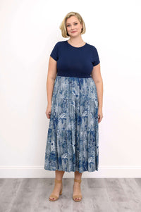 Woman wearing a navy and blue floral print midi dress with short sleeves
