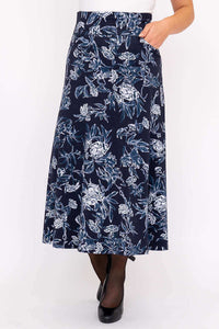 Close-up of model wearing navy blue floral A-line midi skirt with pockets