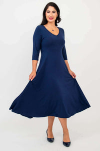 Woman twirling in a navy blue midi dress with a flowy A-line skirt