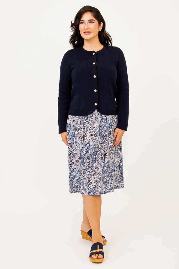 Full front view of navy cardigan paired with blue paisley print skirt