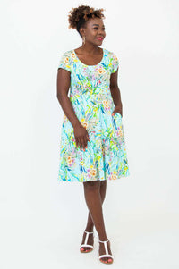 Woman wearing Nicola blue floral cap sleeve A-line dress with pockets, front view