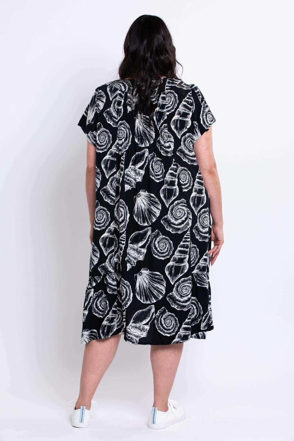Back view of Noosa Dress with shell print and flowy silhouette