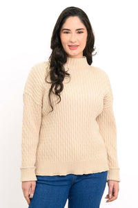 Model posing in a cream mock neck knit sweater, blue denim jeans, and brown leather boots, front-facing view.