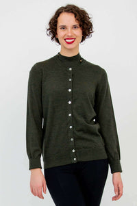 Woman modeling olive-green button-up sweater, mock neck, and black pants, partial view