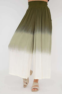Olive ombre wide leg pants in a walking pose showing movement