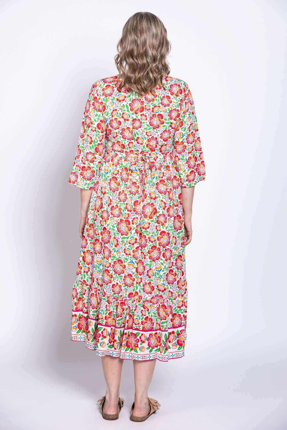 Back view of woman wearing the floral batik midi dress, showing dress detail