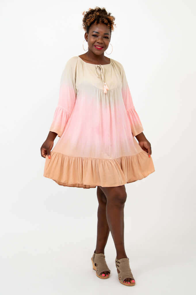 Woman holding out the skirt of a flowy knee-length boho dress