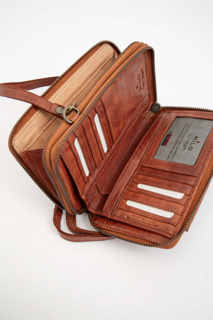 Brown leather wallet open to reveal card slots, ID window, and compartments