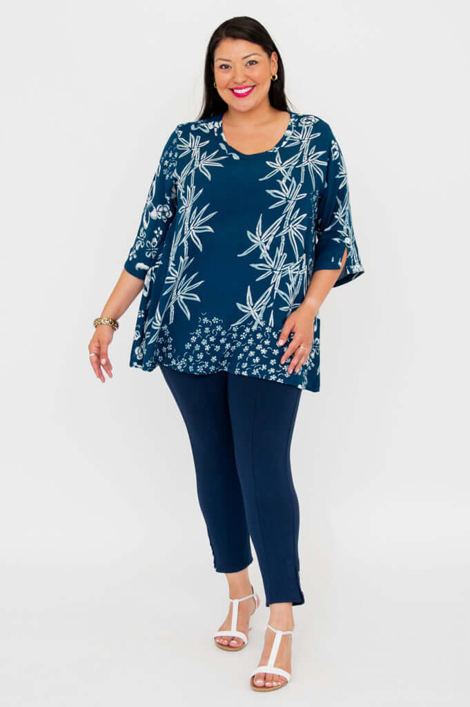 Woman modeling indigo bamboo print blouse, facing slightly to the side