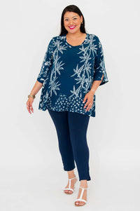 Woman modeling indigo bamboo print blouse, facing slightly to the side