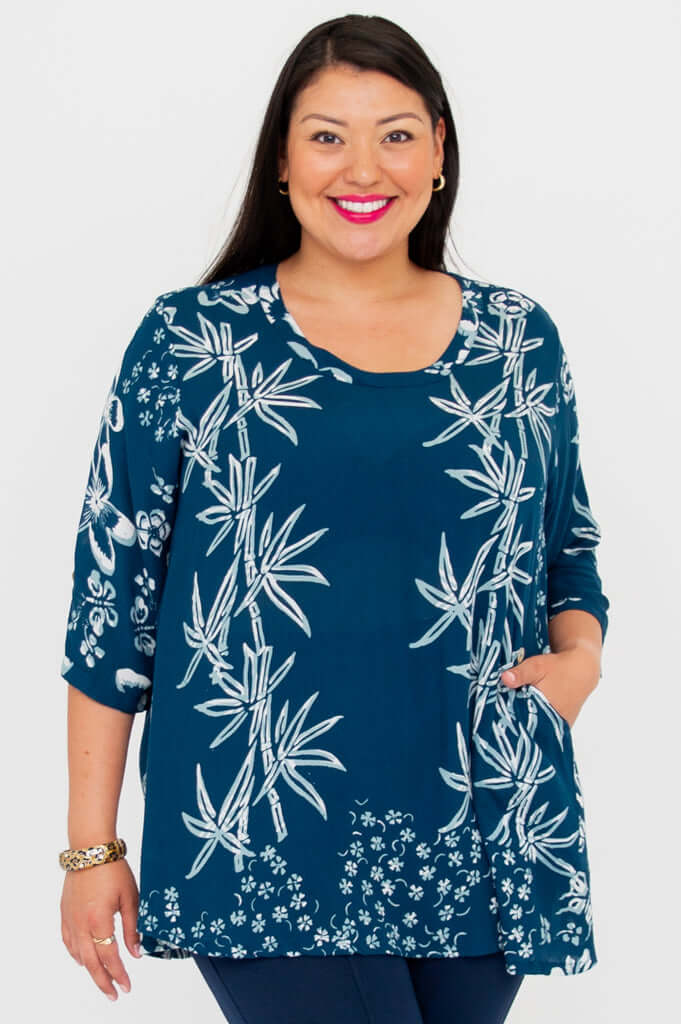 Woman wearing indigo bamboo print blouse with scoop neckline and 3/4 sleeves