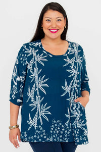 Woman wearing indigo bamboo print blouse with scoop neckline and 3/4 sleeves