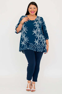 Woman smiling in indigo bamboo blouse with single front pocket and navy pants