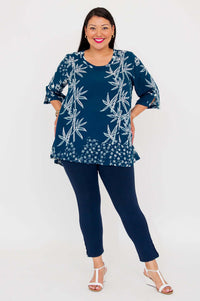 Woman posing in indigo bamboo print blouse with hands on hips