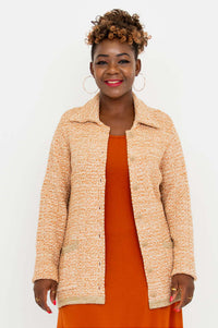 Front partial open view of Parisian Chanel Cardigan with orange dress underneath