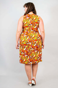 Back view of a plus-size woman in a sleeveless shift dress with orange and yellow print