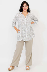 Woman modeling a flowy bamboo-linen tunic with pockets, arms bent, full-length front view