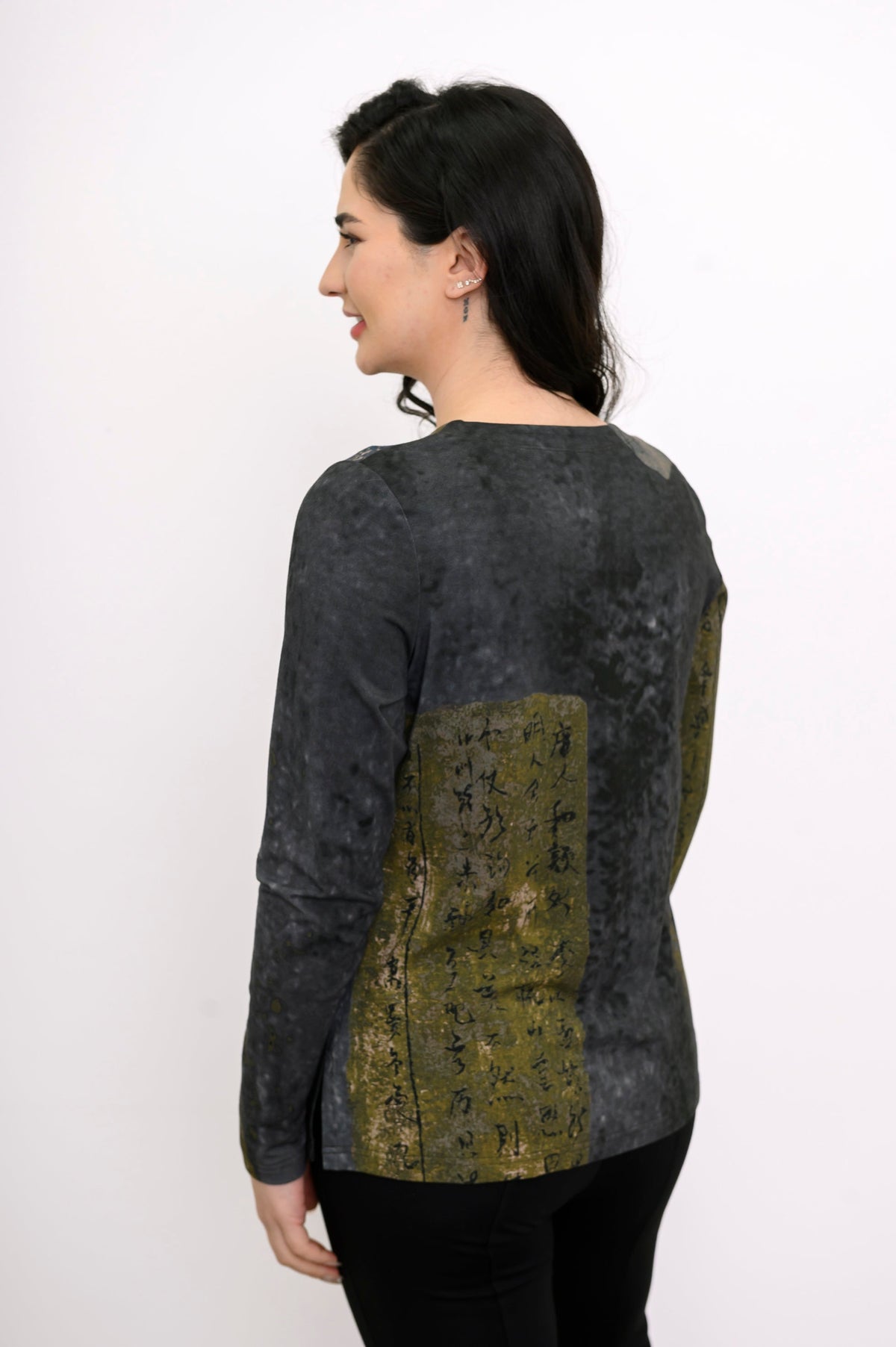 Back view of a relaxed-fit green patterned long-sleeve bamboo top showing the straight hemline and coverage.