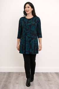 Women's three-quarter sleeve knit tunic in a dark floral print, paired with black trousers in a casual pose.