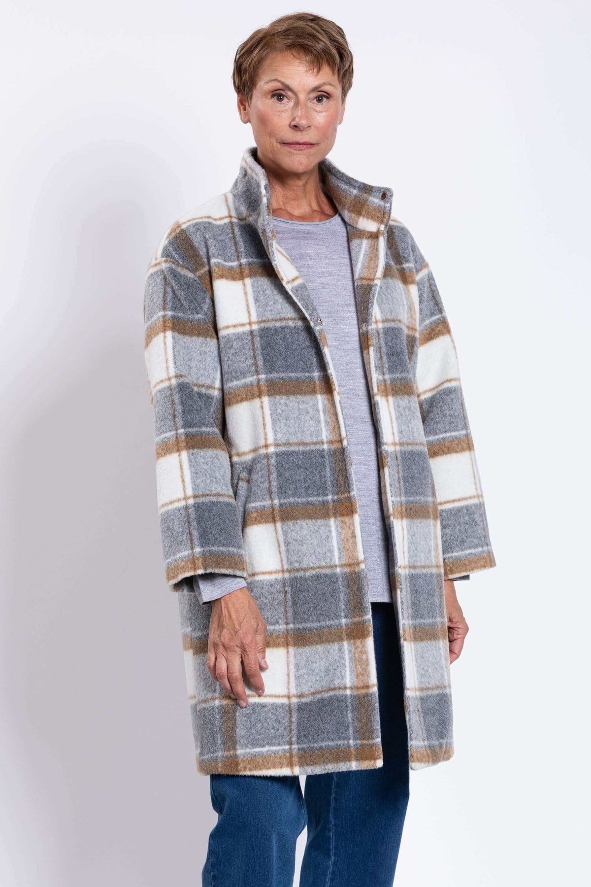 Woman wearing a plaid wool coat with high collar and relaxed fit