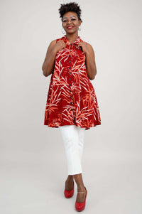 Front pose, woman smiling in red and orange bamboo print sleeveless tank top