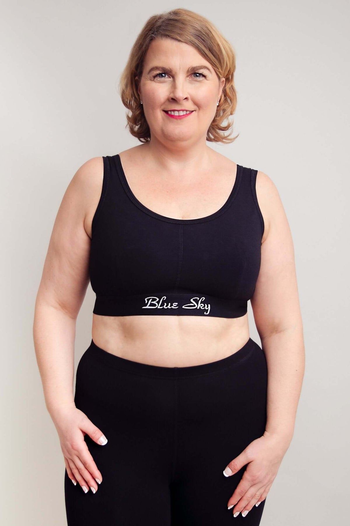 Front view of plus size woman in Blue Sky black comfort bra and pants