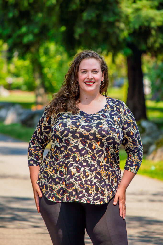Plus size model outdoors in Jackie V-Neck Leopard Top and black pants