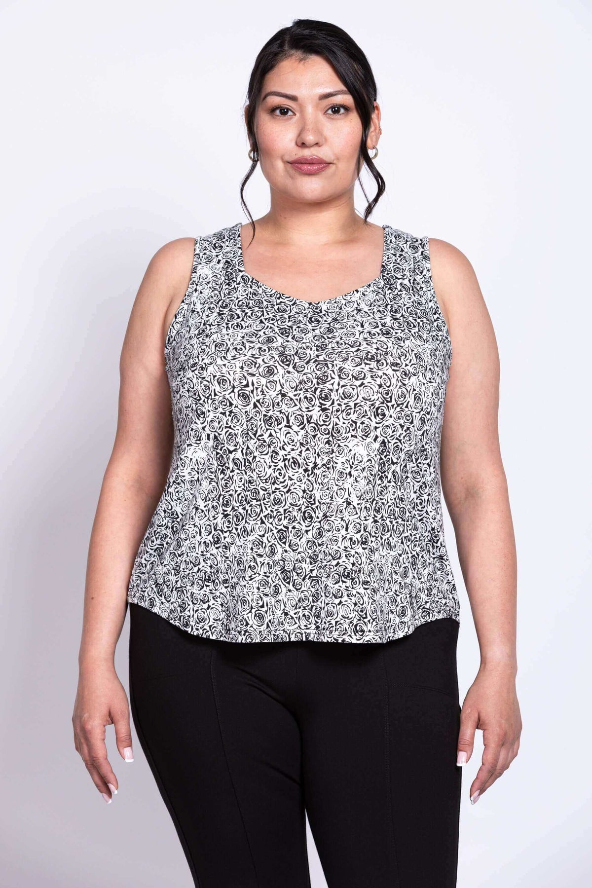 Plus size model in front view of black and white rose tank top with sweetheart neckline