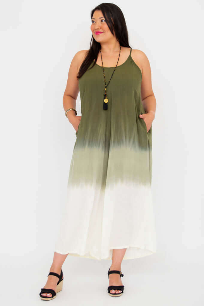 Plus size model wearing green and white gradient jumpsuit with pockets