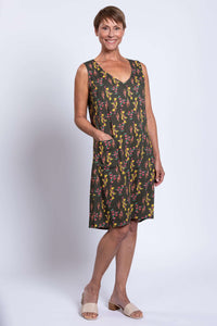 Woman showing front pocket details of sleeveless Felicia dress