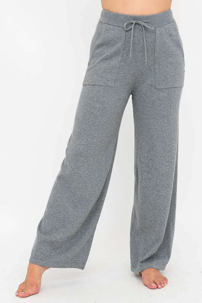 Full front view of grey wide leg lounge pants showing relaxed fit and elastic waistband